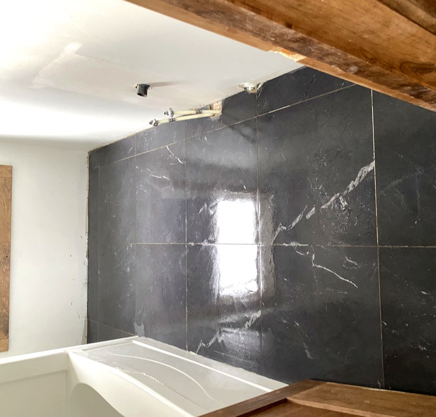 Polished marble-look porcelain floor tile in a renovated Hamilton bathroom
