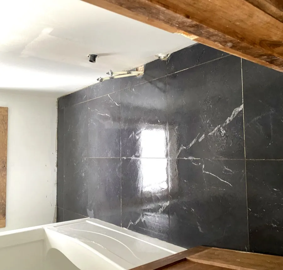 Polished marble-look porcelain floor tile in a renovated Hamilton bathroom