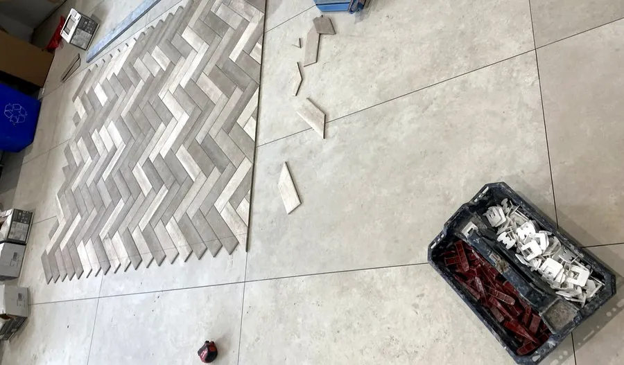 Herringbone pattern floor tile being laid out during a Hamilton bathroom renovation