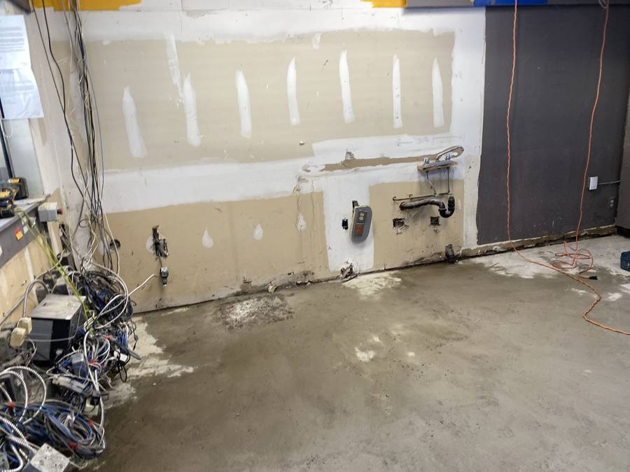 Commercial space in Hamilton after tile demolition and chipping, down to bare concrete slab and stripped walls