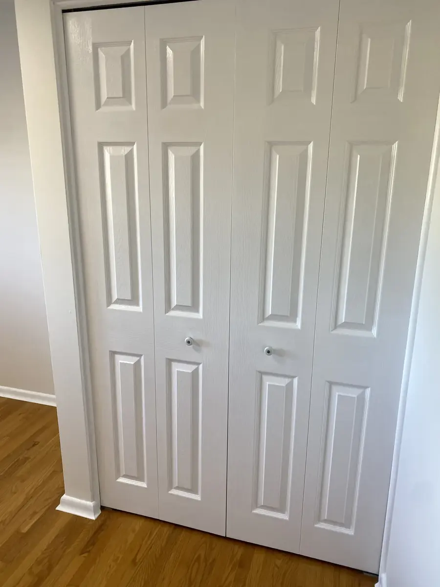 Freshly painted white closet doors in a Hamilton home