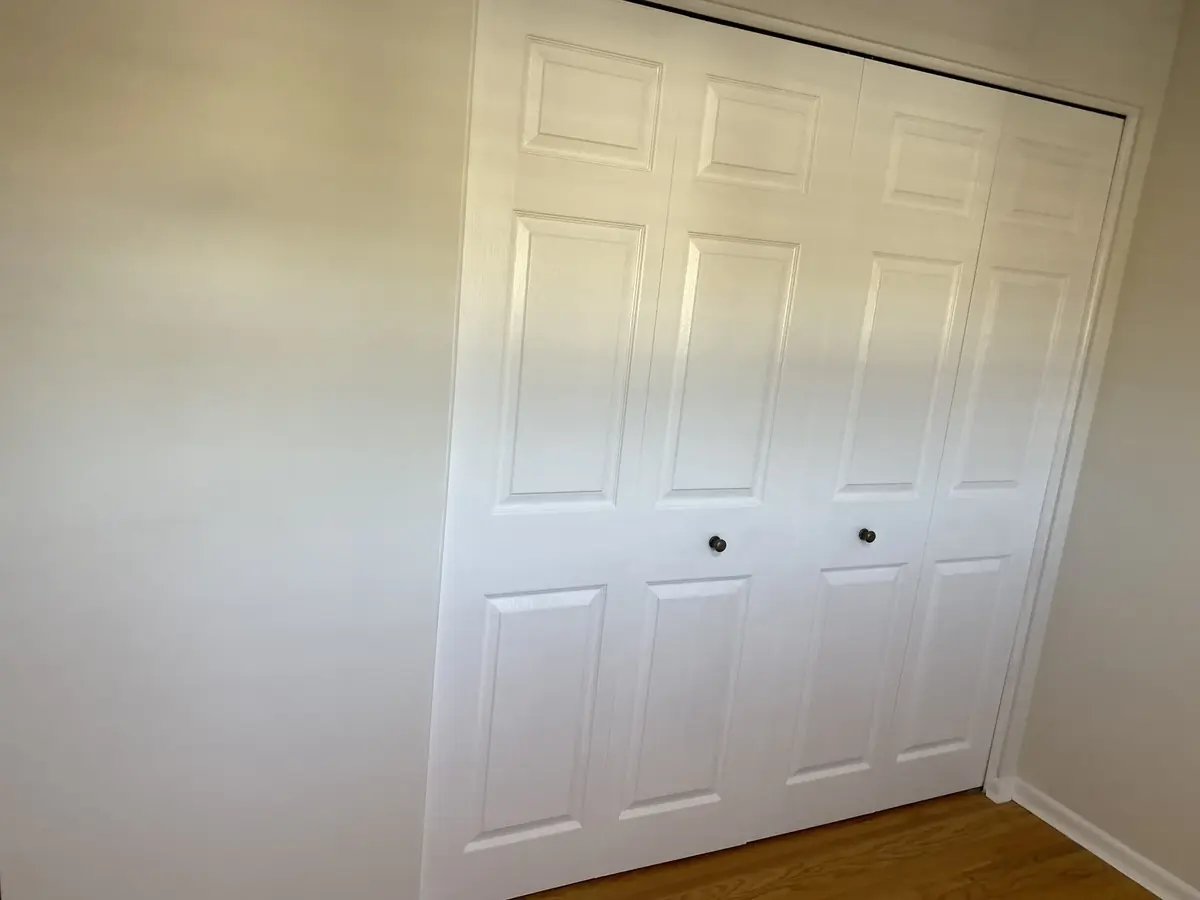 White painted closet doors and surrounding trim