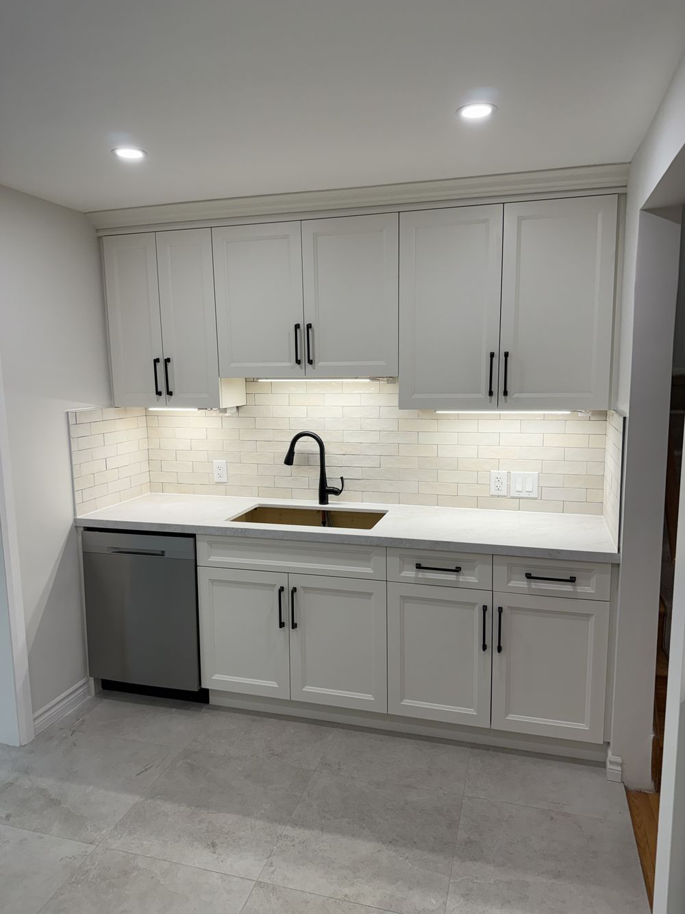 Renovated Ancaster kitchen with white shaker cabinetry, quartz countertop and subway tile backsplash