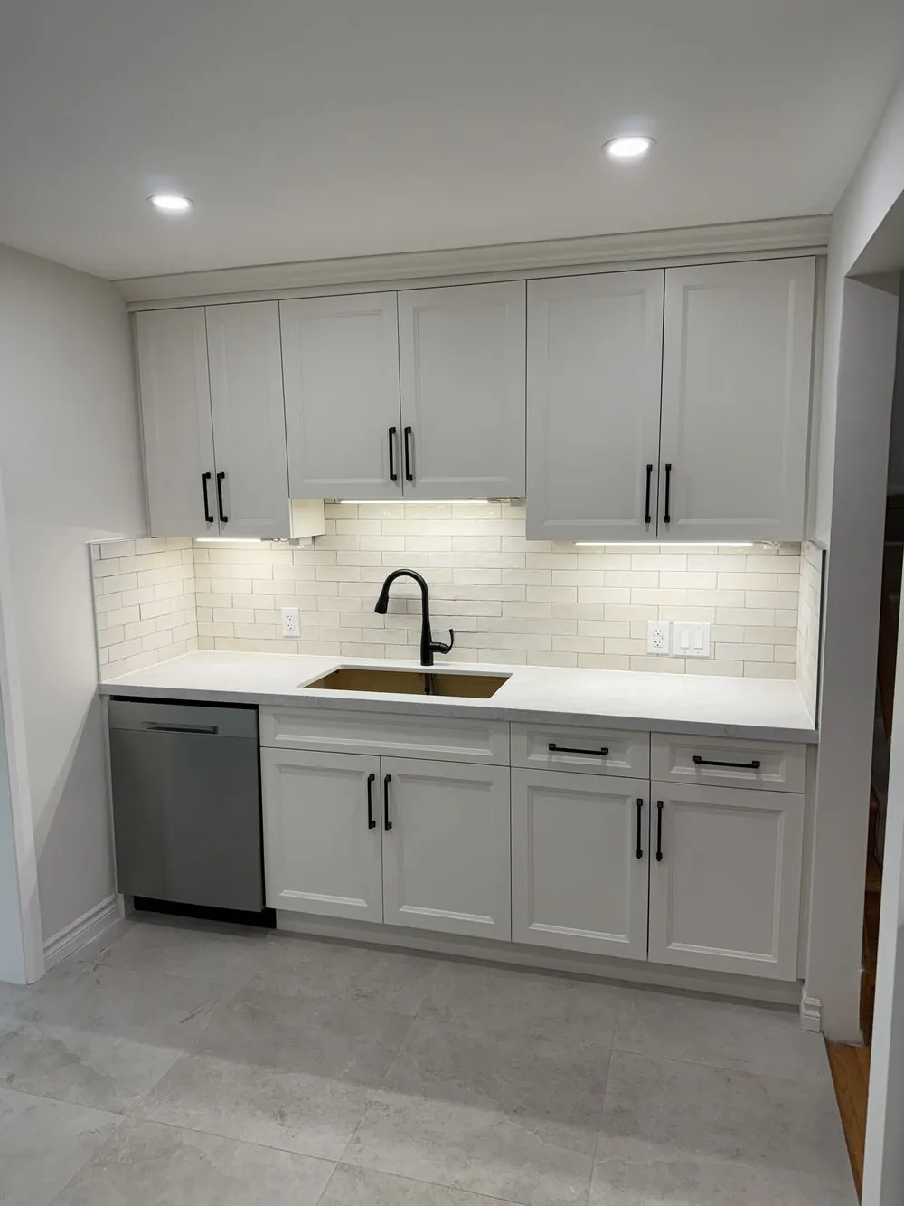 Renovated Ancaster kitchen with white shaker cabinetry, quartz countertop and subway tile backsplash