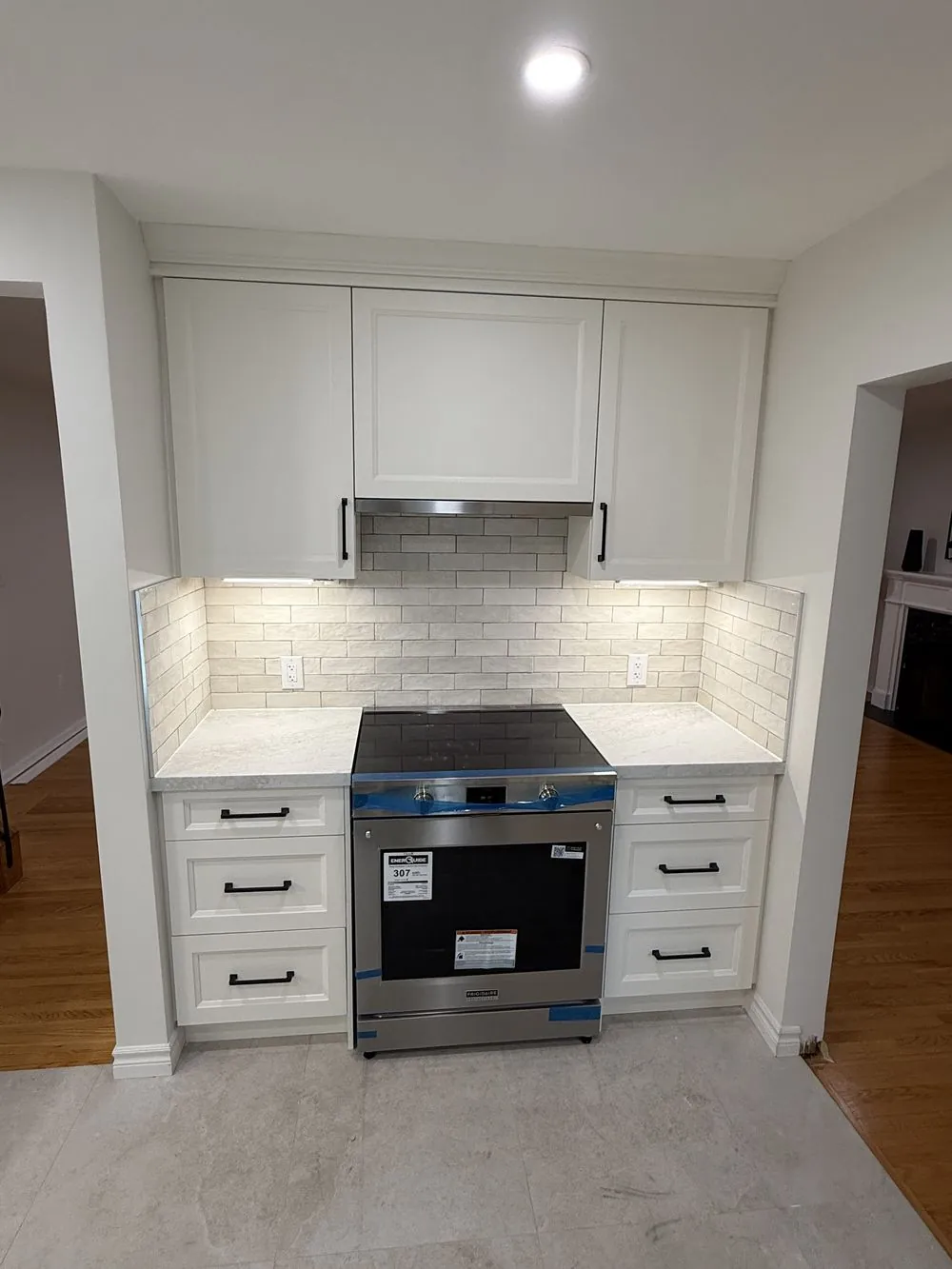 Renovated Ancaster kitchen cooking nook with a new stainless range and subway tile backsplash