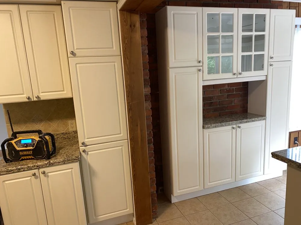 Original Ancaster kitchen pantry wall before renovation, with exposed brick and dated cabinetry