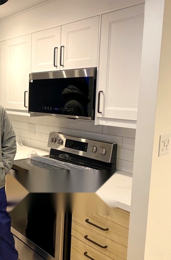 New stove, range hood and cabinetry installed during a Hamilton kitchen renovation